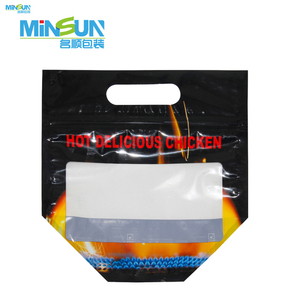 Black hot chicken packaging bag with red text, flame graphic, top handle, and clear window on the front.