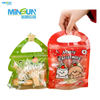 Green Christmas tree gift bag and red bear-themed holiday snack bag with festive Merry Christmas design