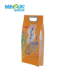 Orange rice packaging bag with a handle, showing illustrated rice fields and Chinese text for a 2.5kg rice product