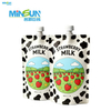 Two strawberry milk pouches with cow-print design and illustrated strawberry field scene.